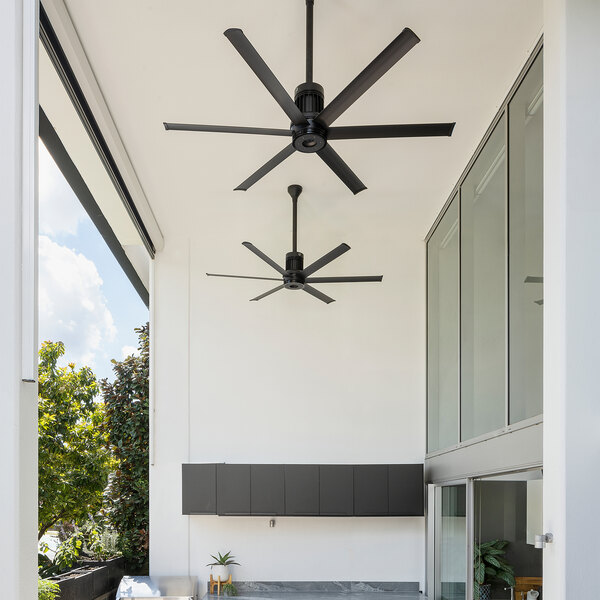 A black Big Ass Fans outdoor ceiling fan on a patio.
