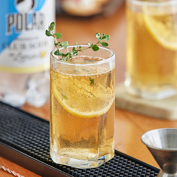 A glass of Polar Lemon Club Soda with a lemon slice on the rim.