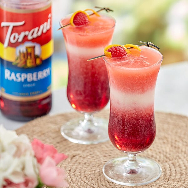 Two glasses of red and pink drinks with Torani Raspberry Flavoring.