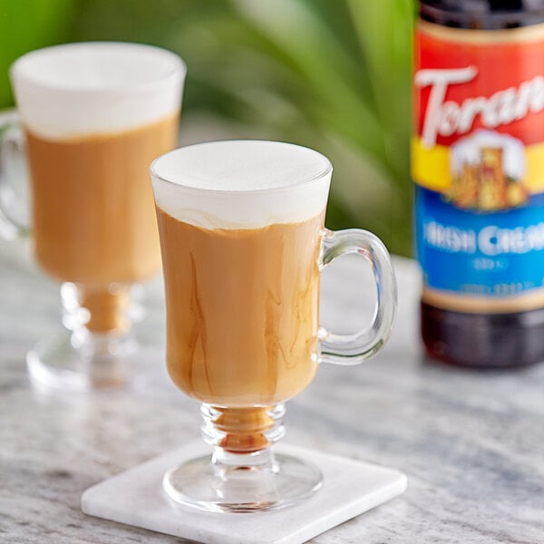 Two glasses of coffee with Torani Irish Cream flavoring.