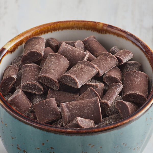 A bowl of Enjoy Life semi-sweet chocolate chunks on a table.