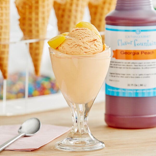 A glass of ice cream with a scoop of Georgia peach flavor in it.