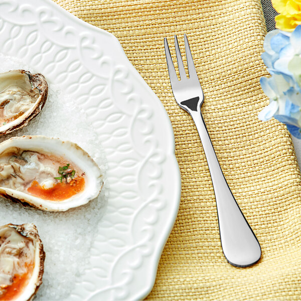 A plate of oysters with a Acopa Vittoria stainless steel cocktail/oyster fork on it.