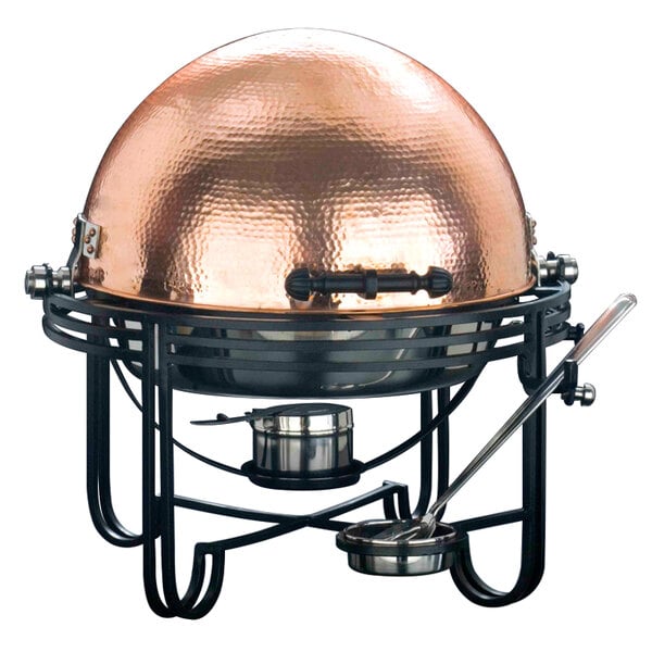 An American Metalcraft round roll top chafer with a hammered copper cover on a black stand.