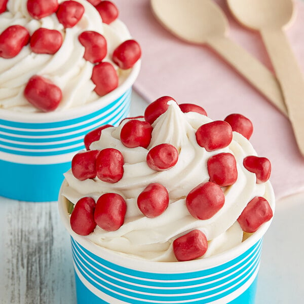 Two cups of ice cream with Red Velvet Cookie Dough Bites on top.