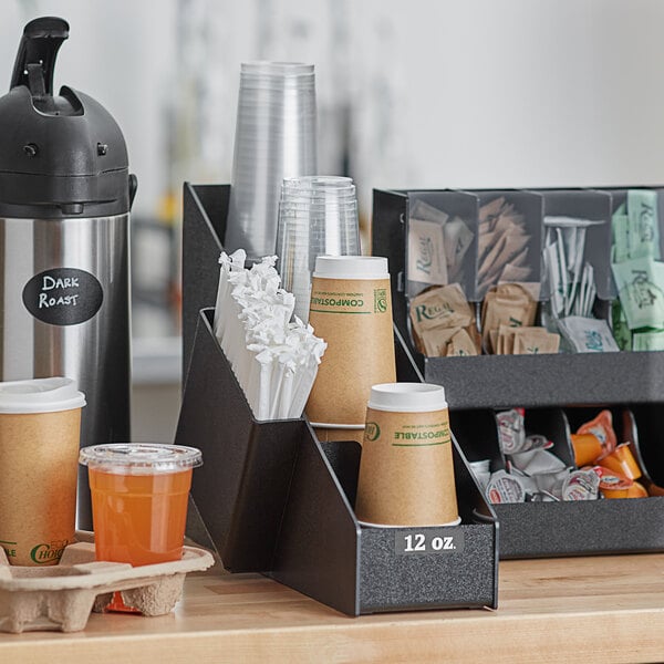 A black ServSense countertop organizer with cups and straws inside.
