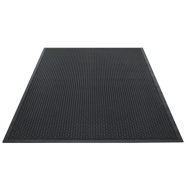 A black rectangular rug with a black border and dots.