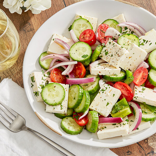 A plate of cucumber, tomato and Krinos Greek Feta cheese salad.