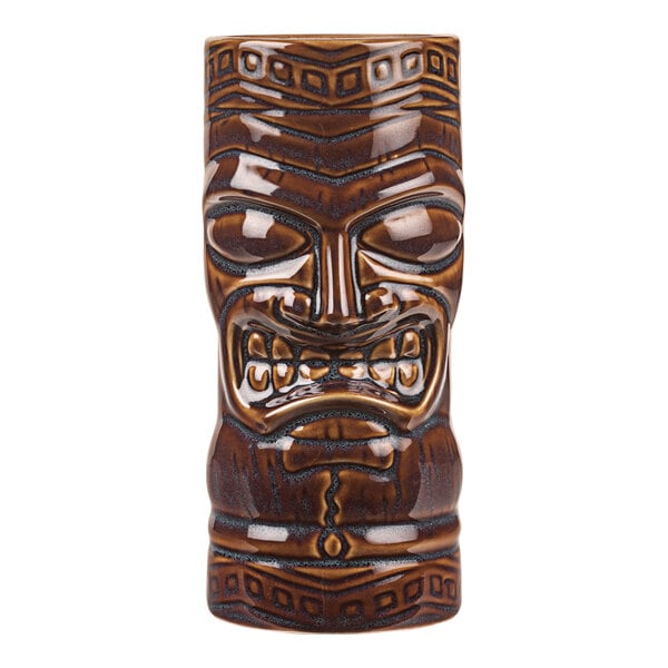 A close up of a brown ceramic Libbey Tiki Tumbler with a face on it.