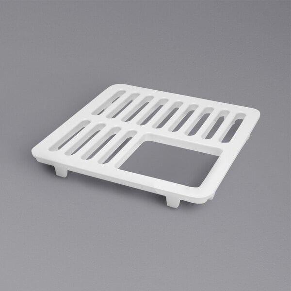 A white enameled Zurn grate with holes in it.