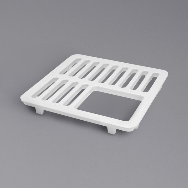 A white enameled cast iron grate with holes in it.