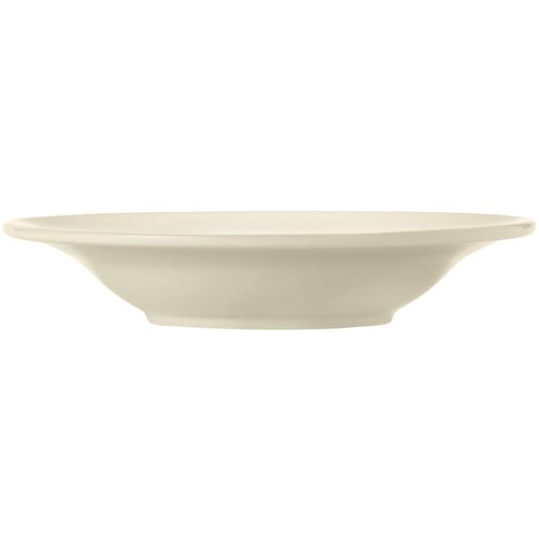 A Libbey Porcelana cream white porcelain deep soup bowl with wide rim and rolled edge.