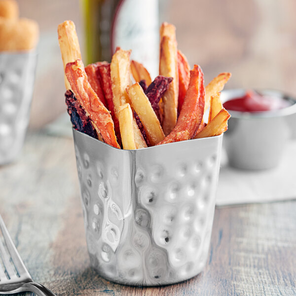 A Tablecraft stainless steel fry cup filled with french fries on a table.