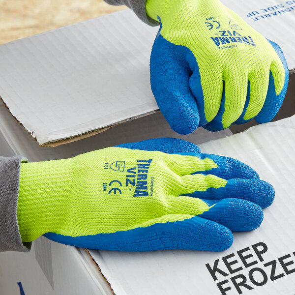 A pair of Cordova warehouse gloves with blue crinkle latex palms and yellow terry thermal coating.
