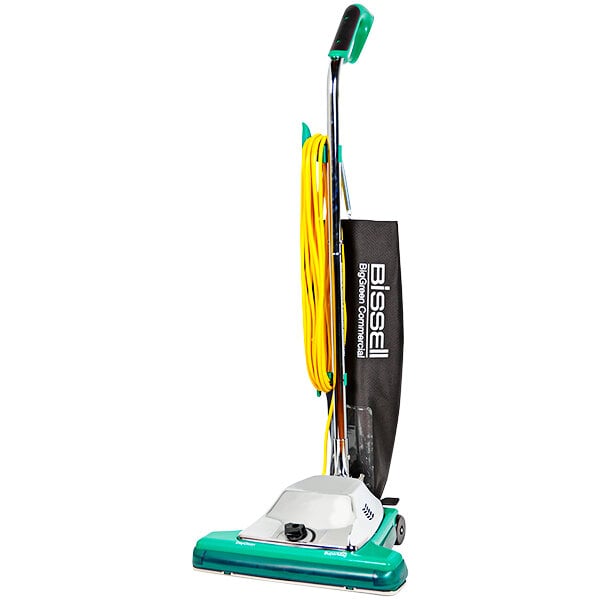 A Bissell Commercial green and white upright vacuum cleaner with a green handle.