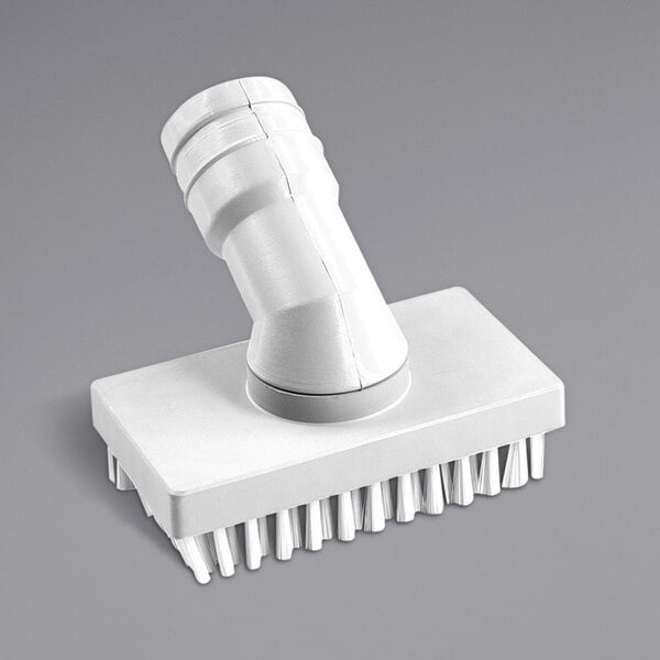 A white rectangular plastic brush for a vacuum cleaner with a hole.