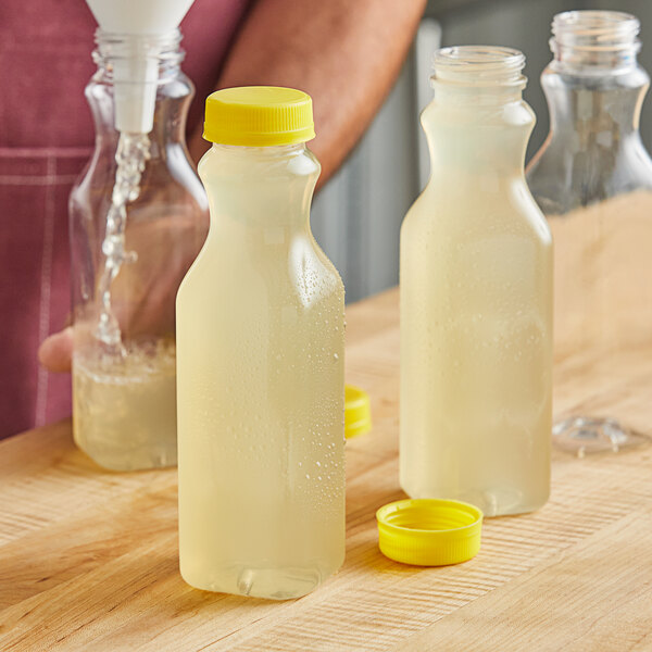 16 oz. Tall Square PET Clear Juice Bottle with Yellow Lid