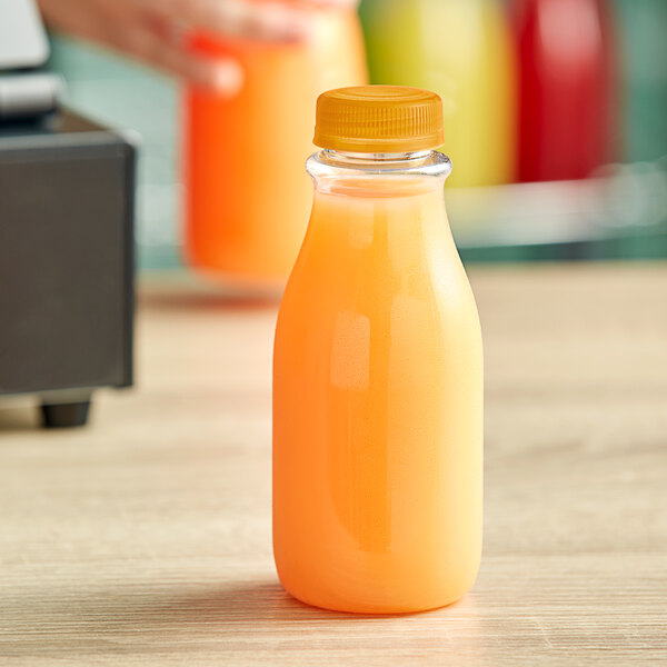 A 12 oz. clear plastic bottle of orange juice with an orange lid.