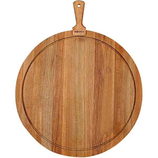 A Boska round European oak serving board with a handle.