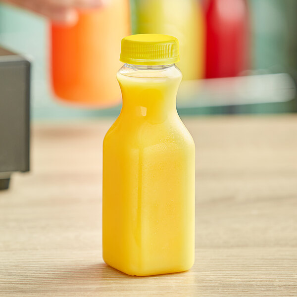 16 oz. Tall Square PET Clear Juice Bottle with Yellow Lid