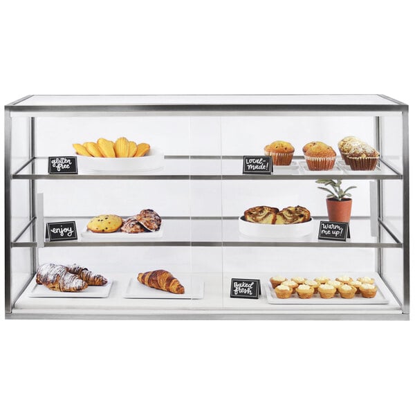 A Cal-Mil 3-tier bakery display case with food inside.