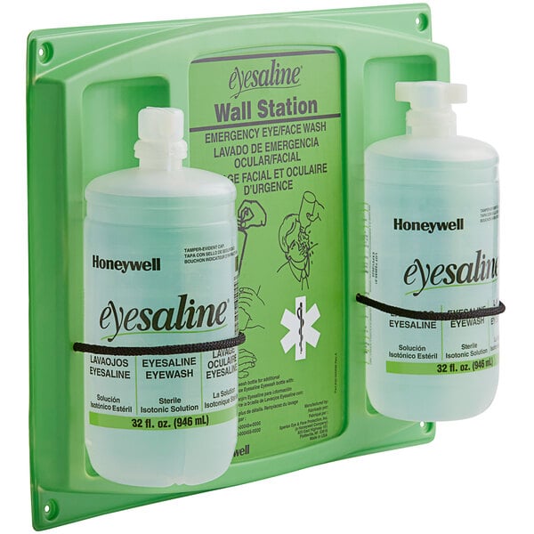 A Honeywell wall station with two bottles of sterile eyewash.