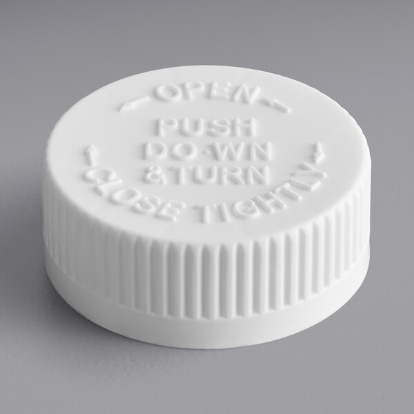 A white 38/400 plastic cap with text reading "Push Down and Turn to Close"
