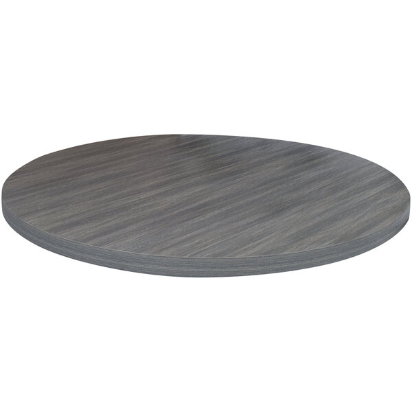 An American Tables & Seating round light gray faux wood laminate table top on a table.