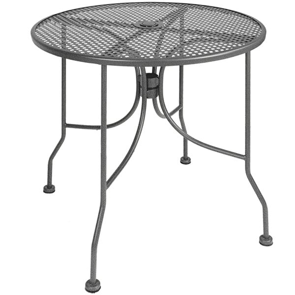 An American Tables & Seating round metal table with a mesh top and umbrella hole.