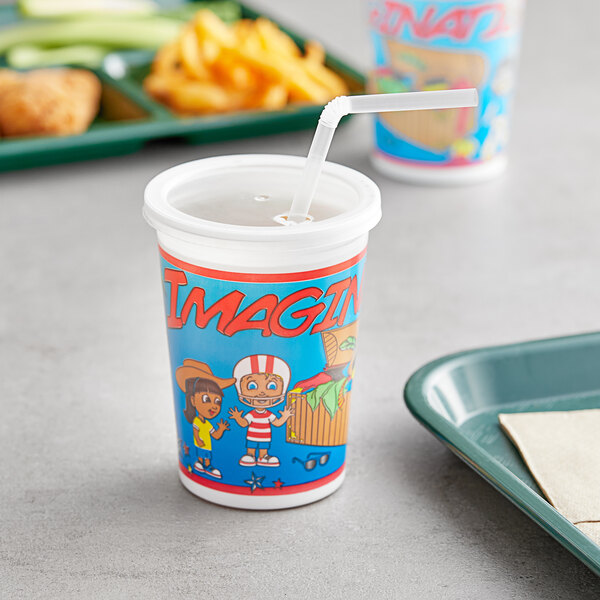 A Royal Paper plastic cup with a lid and straw on a table with food.