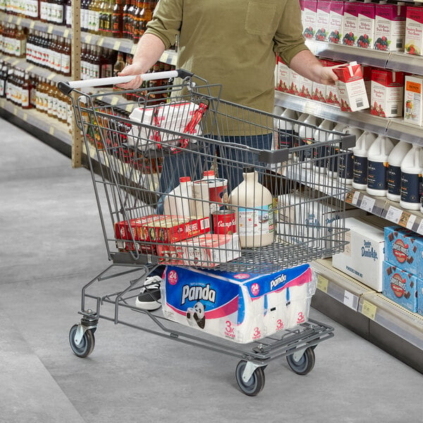 A man pushing a Regency Supermarket gray shopping cart in a grocery store aisle.