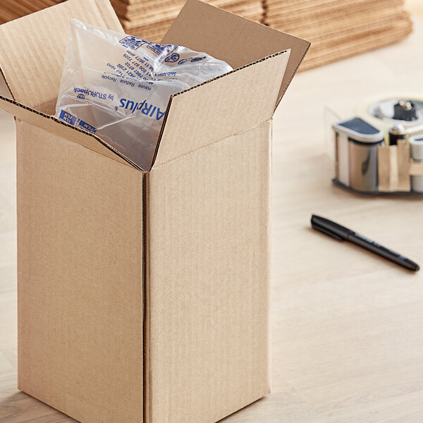A Lavex kraft cardboard shipping box with a package inside.