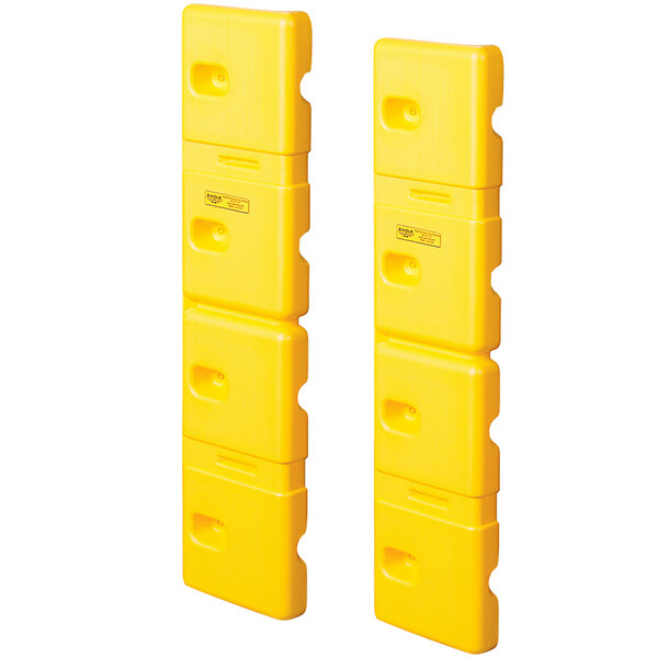 Two yellow plastic Eagle Manufacturing wall protectors with holes in them.