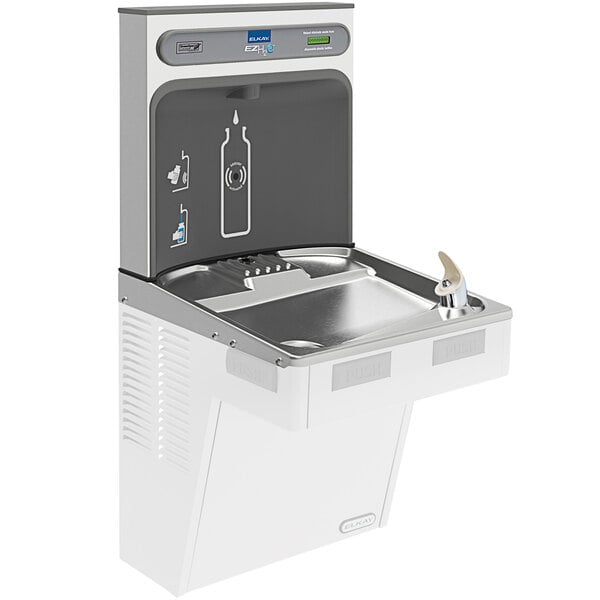 An Elkay stainless steel bottle filling station over a drinking fountain with a bottle filler.