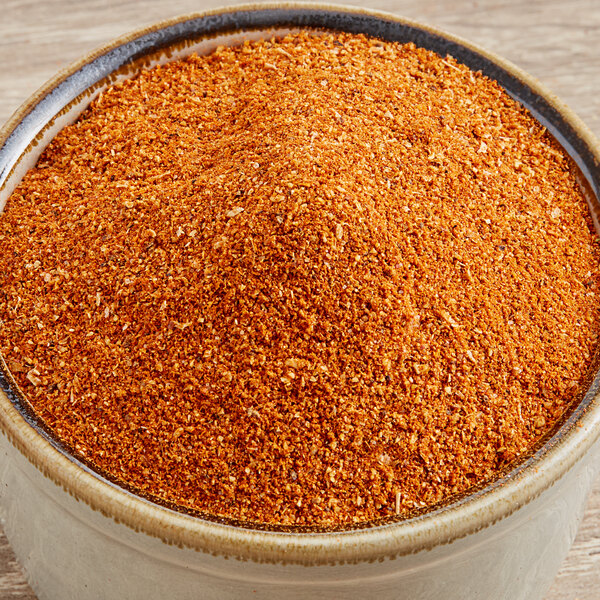 A bowl of Regal Cajun Wing Rub on a wooden table.