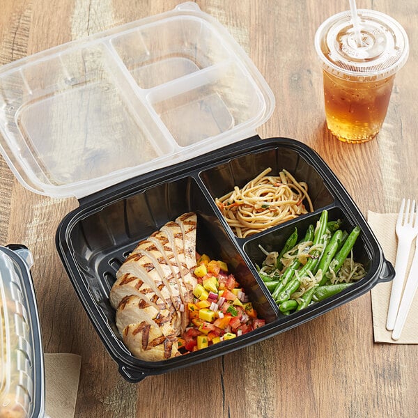 A black plastic Choice 3-compartment container with food inside.