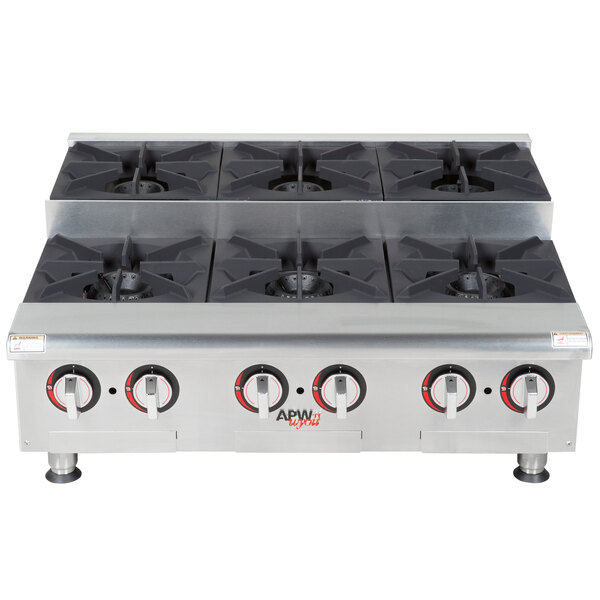 An APW Wyott stainless steel countertop range with four burners.