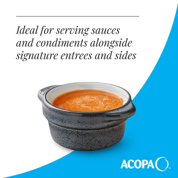 A small midnight blue matte stoneware sauce cup filled with sauce.