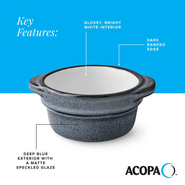 A small stoneware sauce cup with a deep blue matte speckled exterior, glossy white interior, and a dark banded edge.