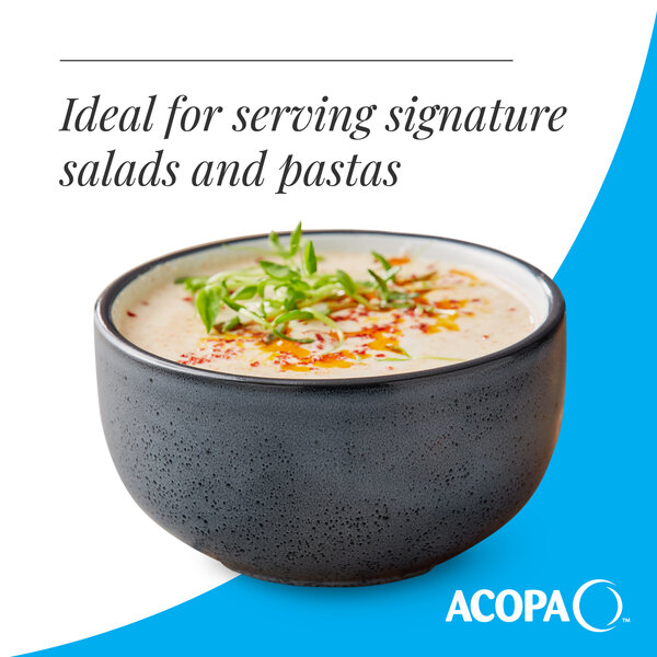 A matte midnight blue stoneware bowl filled with a creamy dish and garnished with herbs.