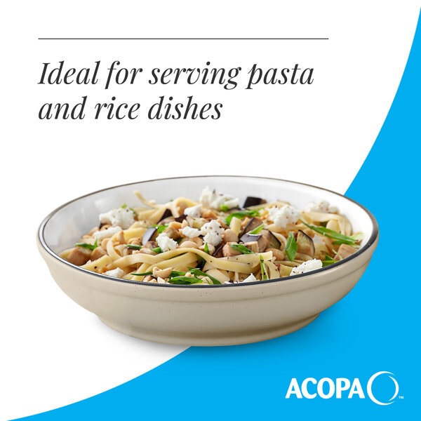 A cream white matte stoneware pasta bowl filled with pasta and vegetables.