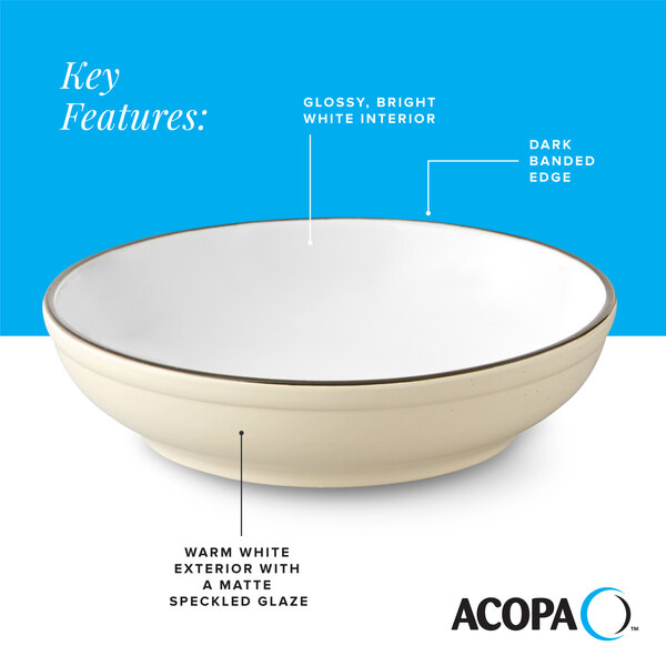 A cream white matte stoneware pasta bowl with a glossy white interior and a dark banded edge.