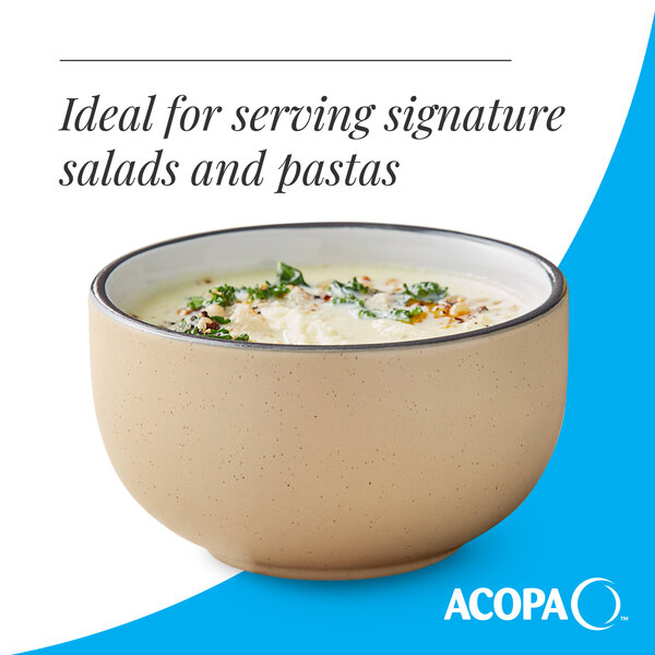 A tan matte stoneware bowl filled with food, ideal for serving salads and pastas.