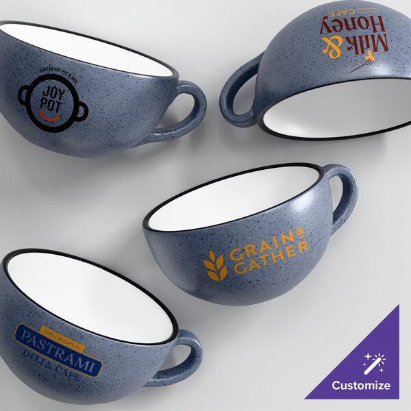 A set of four customizable midnight blue matte stoneware cups with various printed logos.