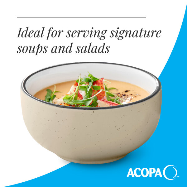 A cream white matte stoneware bowl with a speckled finish, ideal for serving soups and salads.