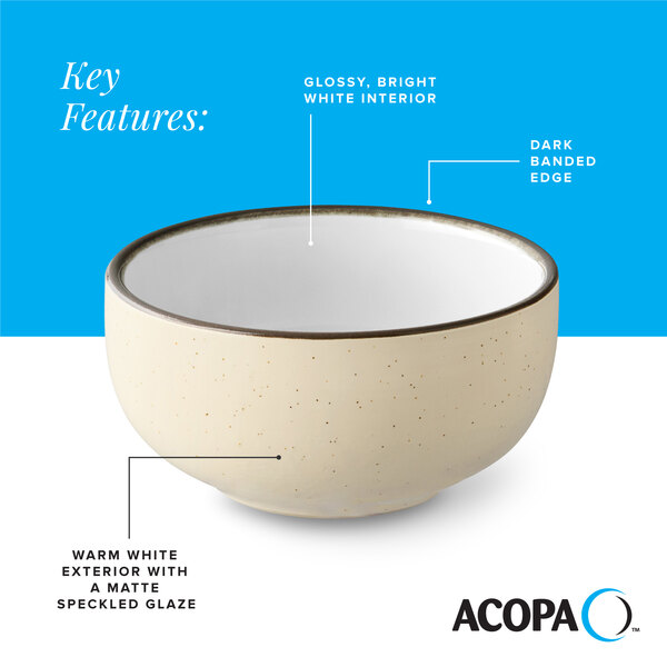 A cream white matte stoneware bowl with a glossy white interior, dark banded edge, and speckled exterior.