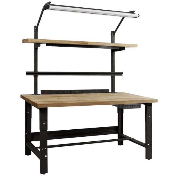 A BenchPro Roosevelt workbench with a wooden butcher block top and black legs with a light above it.