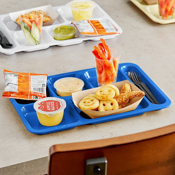 A blue Choice right-handed compartment tray with food and a yellow cup on it.