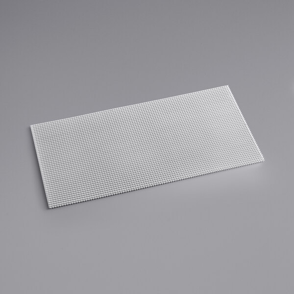 A white rectangular aluminum louver on a gray surface.