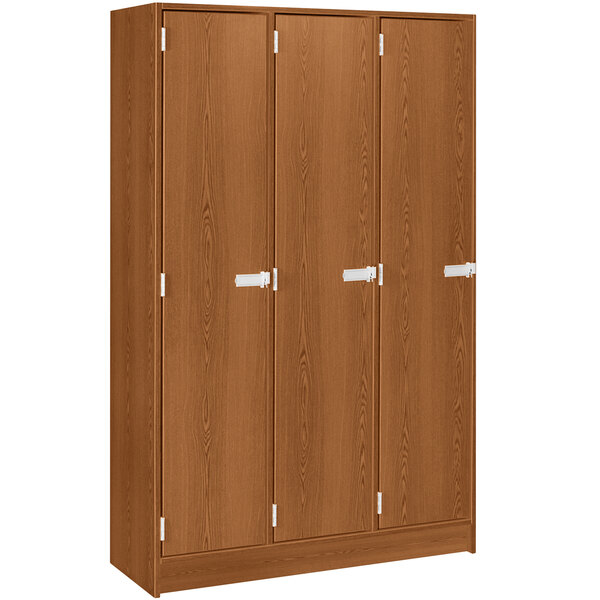 A medium cherry wooden storage locker with three doors and two shelves.